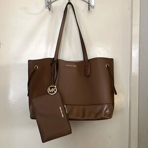 Brown Micheal Kors bag and wallet together.